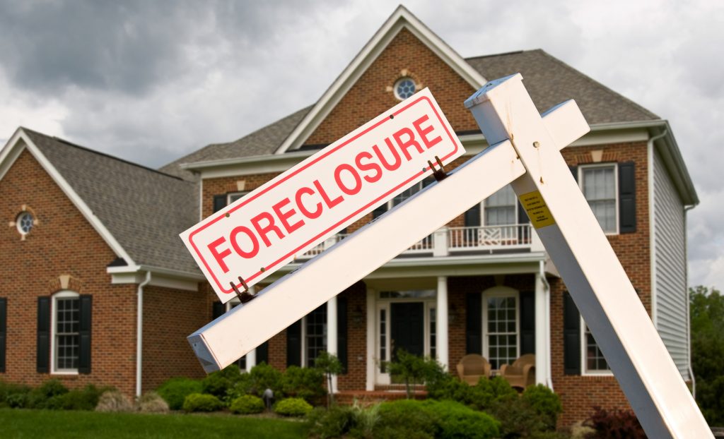 foreclosure sign in front of home