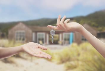 hands holding keys to home