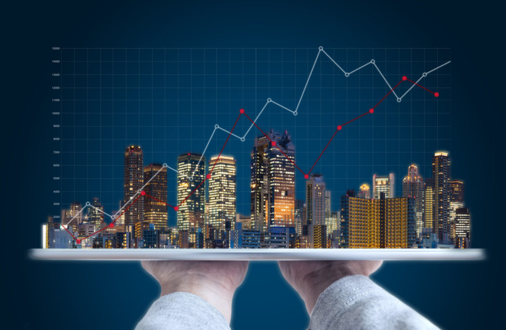 person holding city scape with graph