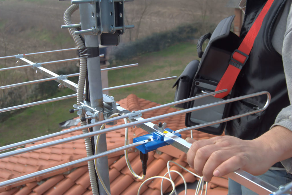 Person Installing an Antenna on a Rooftop